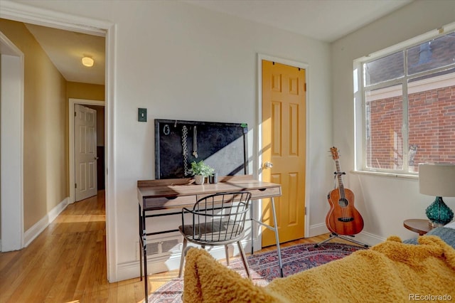 office area with light hardwood / wood-style floors