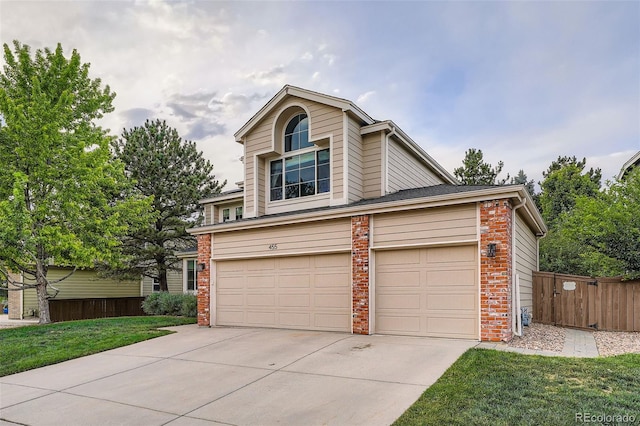 455 Bexley St, Littleton, CO 80126 - view of front of property featuring driveway, brick siding, and an attached garage
