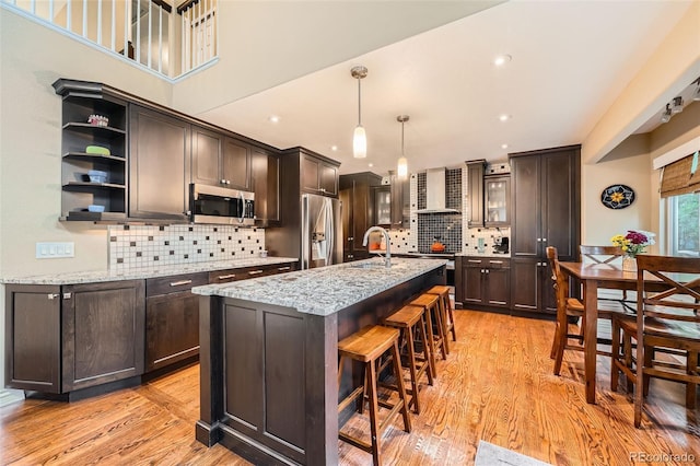455 Bexley St, Littleton, CO 80126 - kitchen featuring stainless steel appliances, light wood-style flooring, dark brown cabinets, and recessed lighting