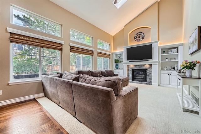 455 Bexley St, Littleton, CO 80126 - living room with high vaulted ceiling, a stone fireplace, and built in features