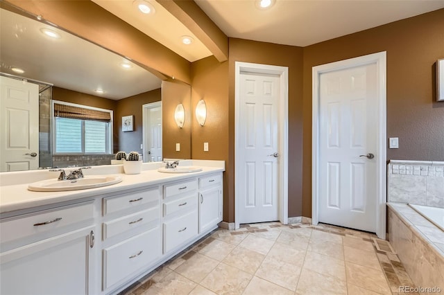 455 Bexley St, Littleton, CO 80126 - bathroom with double vanity, a relaxing tiled tub, recessed lighting, and tile patterned floors