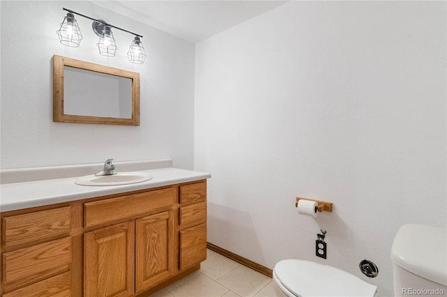 bathroom with tile patterned flooring, vanity, and toilet