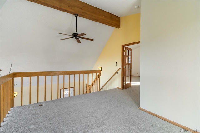 carpeted spare room with beamed ceiling, high vaulted ceiling, and ceiling fan