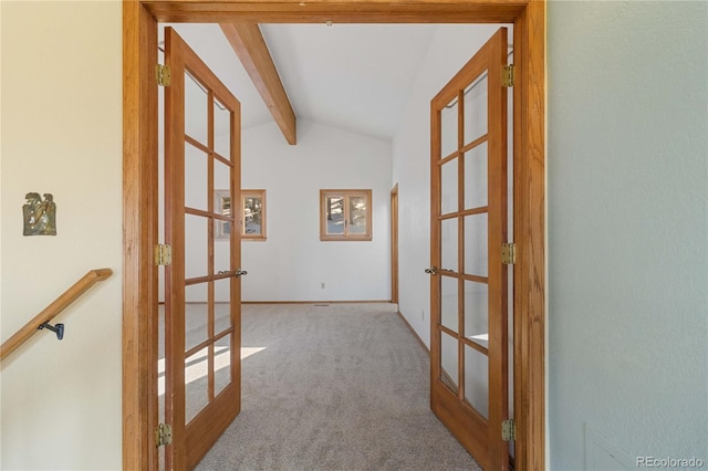 hall with vaulted ceiling with beams, light colored carpet, and french doors