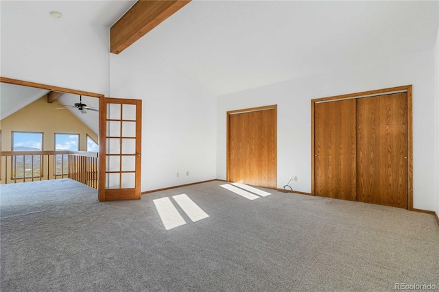 unfurnished living room featuring carpet flooring, lofted ceiling with beams, ceiling fan, and french doors