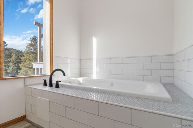 bathroom featuring tiled bath