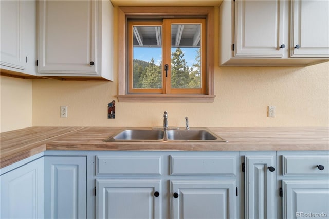 kitchen with sink and white cabinets