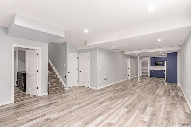 16321 Clayton St, Thornton, CO 80602 - unfurnished living room with stairs, light wood-style floors, and recessed lighting