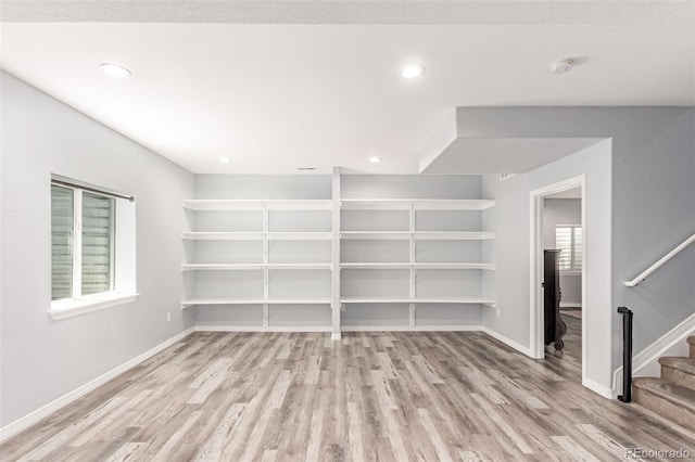 16321 Clayton St, Thornton, CO 80602 - empty room featuring light wood-style flooring, a smoke detector, stairs, and recessed lighting