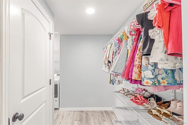 16321 Clayton St, Thornton, CO 80602 - walk in closet with light wood-style floors and washer / clothes dryer