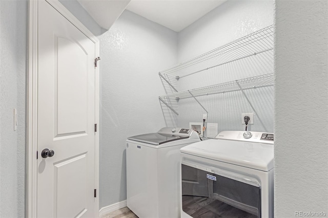 16321 Clayton St, Thornton, CO 80602 - laundry area featuring washing machine and clothes dryer, a textured wall, and light wood-style flooring