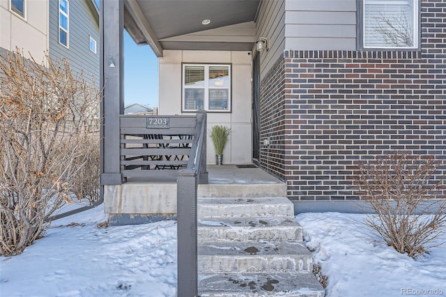 view of snow covered property entrance