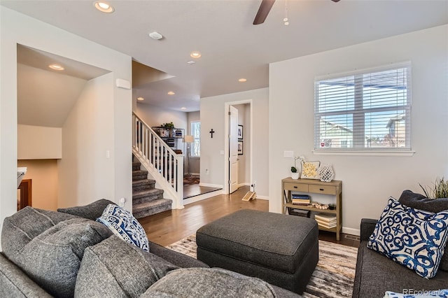 living room featuring wood-type flooring and ceiling fan