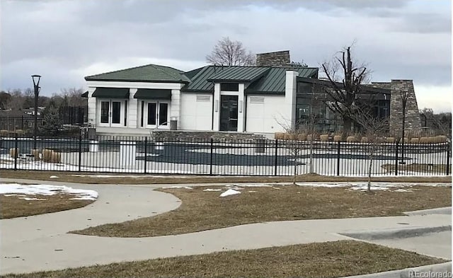 view of front of property with a covered pool