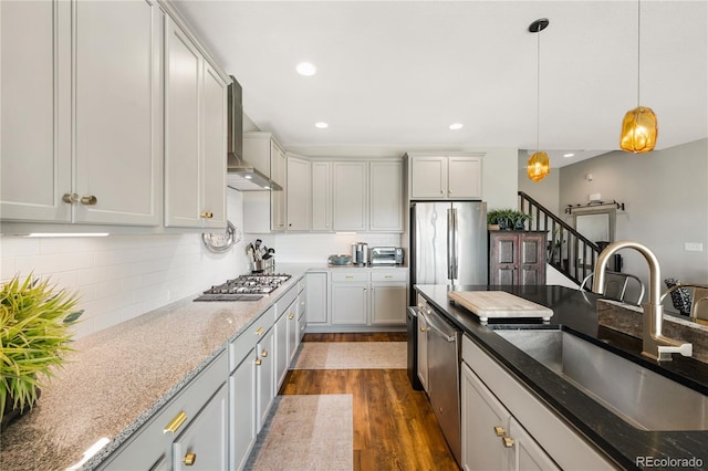 8872 E 47th Ave, Denver, CO 80238 - kitchen with stainless steel appliances, wall chimney range hood, decorative light fixtures, dark wood-style floors, and backsplash