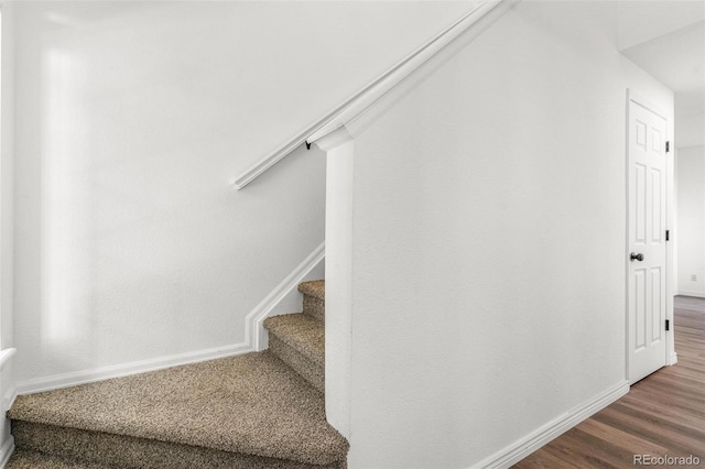 stairs with wood-type flooring