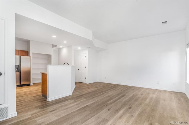 unfurnished living room with light hardwood / wood-style flooring