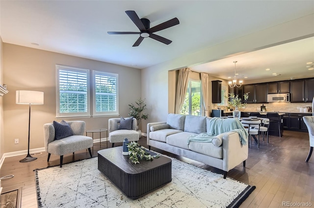 living area with plenty of natural light, a chandelier, light wood finished floors, and recessed lighting