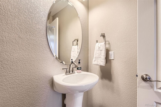 bathroom with a textured wall