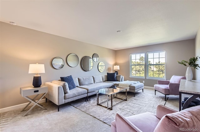 living room with light carpet and baseboards