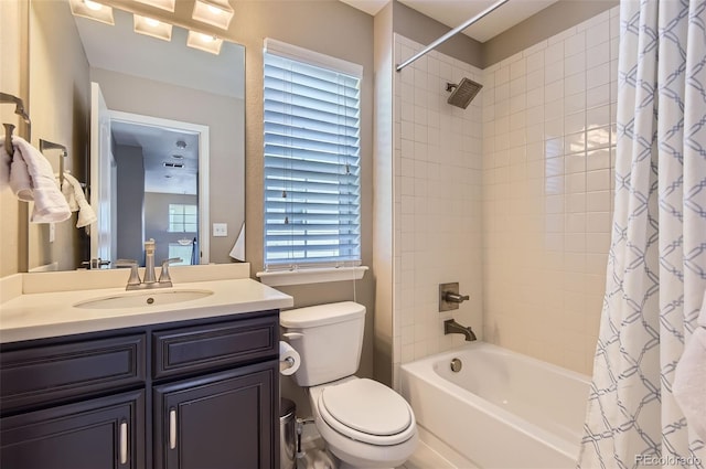 full bath with toilet, shower / bath combo with shower curtain, and vanity