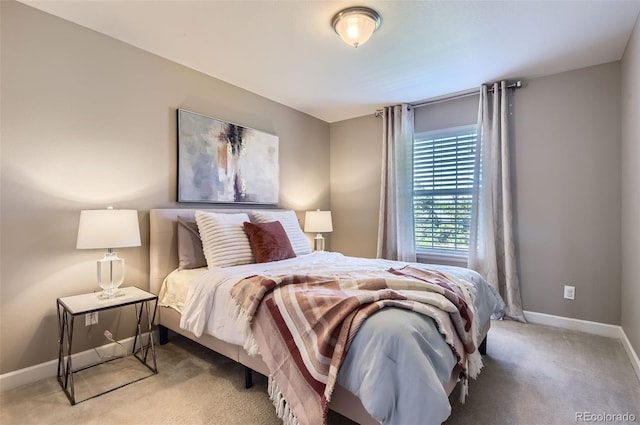 bedroom with baseboards and carpet floors