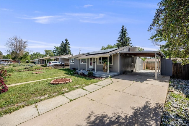 7350 Dale Ct, Westminster, CO 80030 - ranch-style home with covered porch, concrete driveway, solar panels, and an attached carport