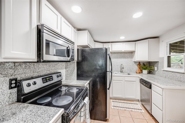 7350 Dale Ct, Westminster, CO 80030 - kitchen with appliances with stainless steel finishes, white cabinets, light countertops, decorative backsplash, and recessed lighting