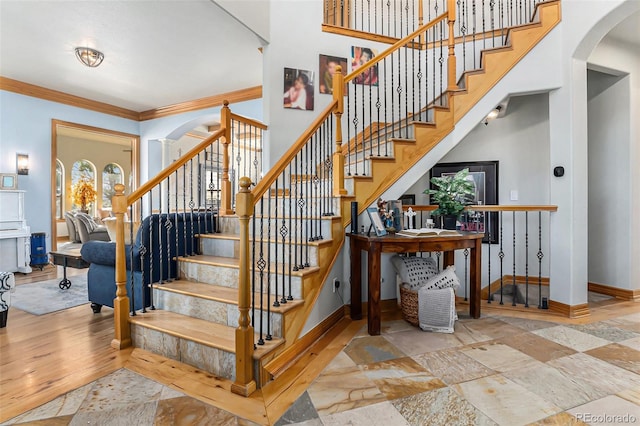12161 S Leaning Pine Ct, Parker, CO 80134 - stairs featuring arched walkways, baseboards, ornamental molding, and stone tile flooring