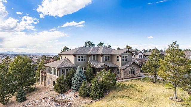 12161 S Leaning Pine Ct, Parker, CO 80134 - craftsman inspired home with a front yard, a shingled roof, and stone siding