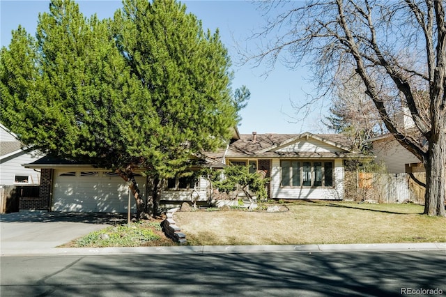 view of front facade with fence, an attached garage, driveway, a front yard, and brick siding