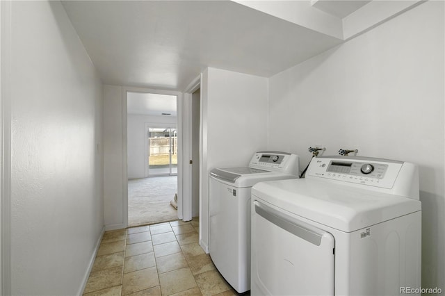 washroom featuring washing machine and clothes dryer and baseboards