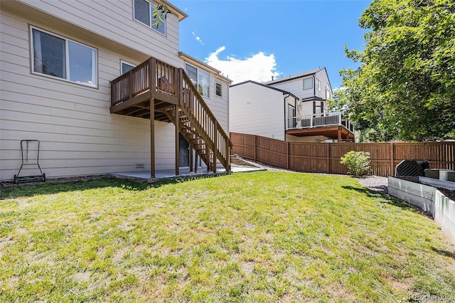 9651 Lameria Dr, Highlands Ranch, CO 80130 - fenced backyard featuring a wooden deck, stairway, and a patio area