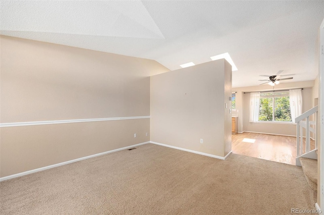 9651 Lameria Dr, Highlands Ranch, CO 80130 - empty room featuring carpet, stairway, ceiling fan, and vaulted ceiling