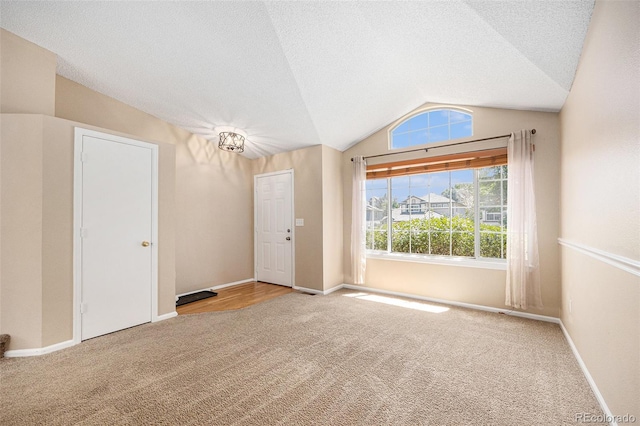 9651 Lameria Dr, Highlands Ranch, CO 80130 - foyer with vaulted ceiling, carpet floors, and a textured ceiling