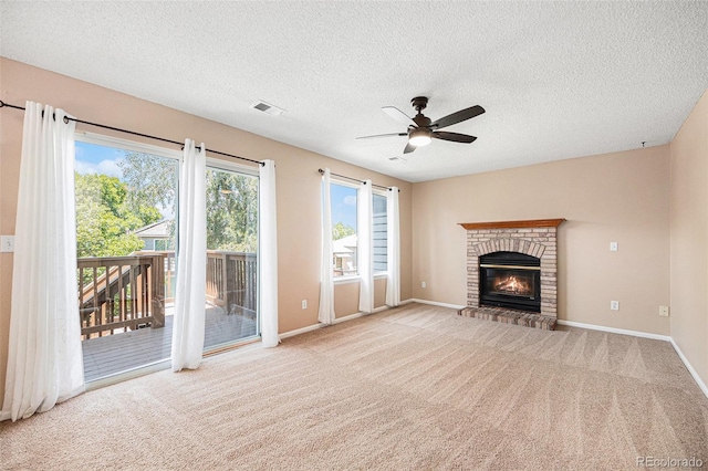 9651 Lameria Dr, Highlands Ranch, CO 80130 - unfurnished living room featuring a ceiling fan, a textured ceiling, a brick fireplace, and carpet