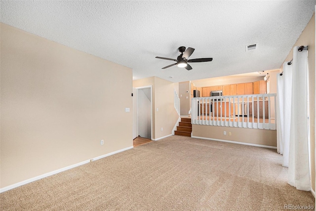9651 Lameria Dr, Highlands Ranch, CO 80130 - carpeted spare room featuring a ceiling fan, a textured ceiling, and stairs