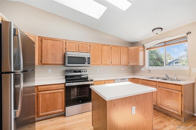 9651 Lameria Dr, Highlands Ranch, CO 80130 - kitchen with stainless steel appliances, lofted ceiling, a skylight, light countertops, and light wood-style floors
