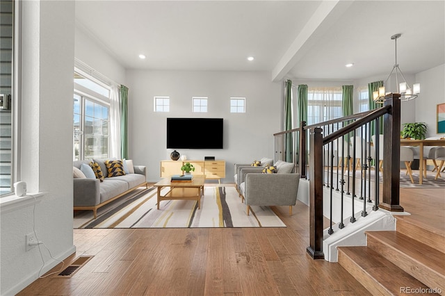 living room with a notable chandelier and light wood-type flooring