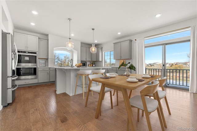 kitchen with a center island, decorative backsplash, gray cabinets, and stainless steel appliances