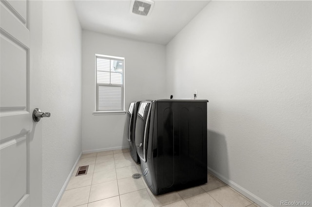 laundry area featuring light tile patterned flooring and washer and dryer