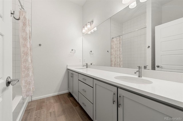 bathroom with shower / bathtub combination with curtain, vanity, and hardwood / wood-style flooring