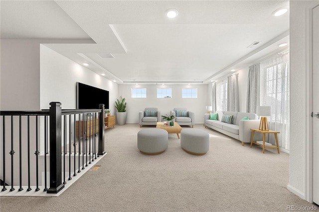 living room featuring carpet and plenty of natural light