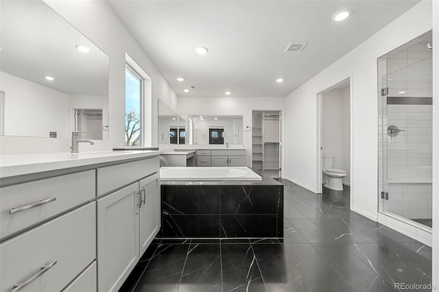 full bathroom with separate shower and tub, vanity, and toilet