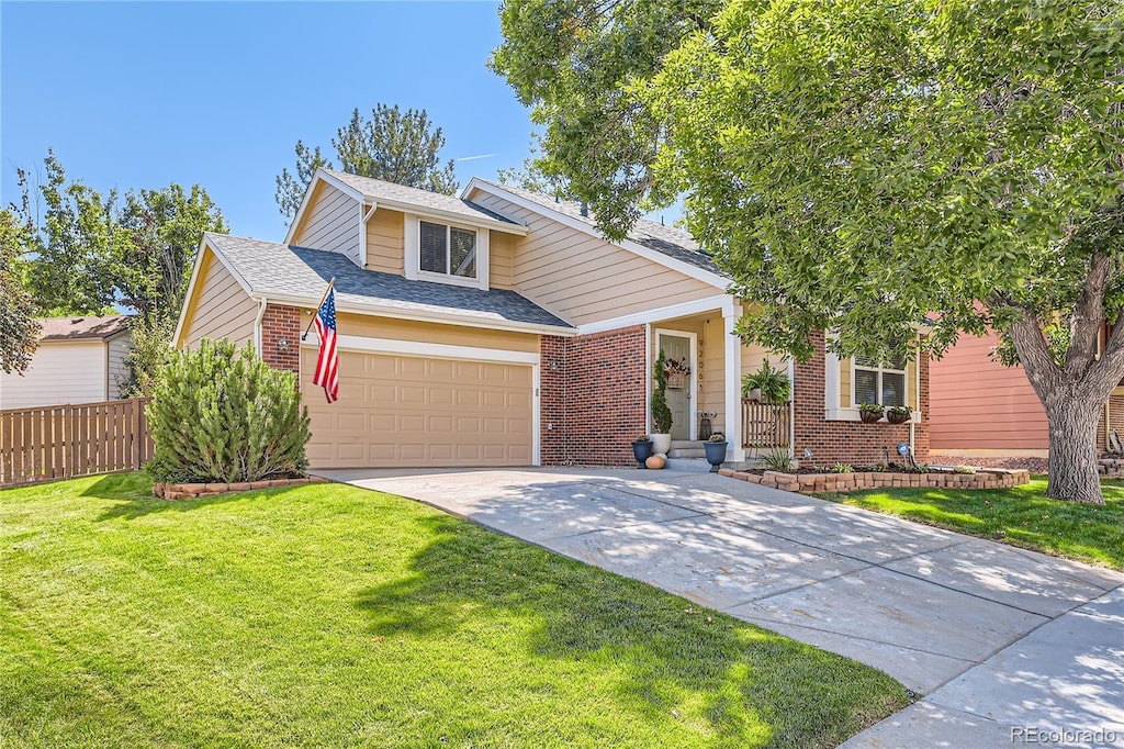 view of front of house with a garage and a front lawn