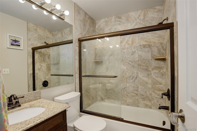 full bathroom with vanity, toilet, and combined bath / shower with glass door