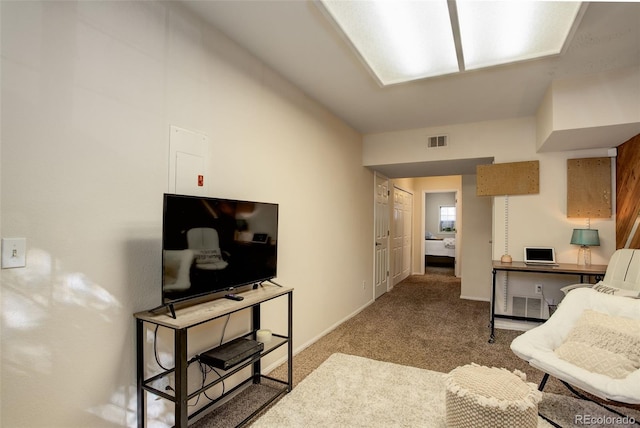 living area with carpet flooring, baseboards, and visible vents