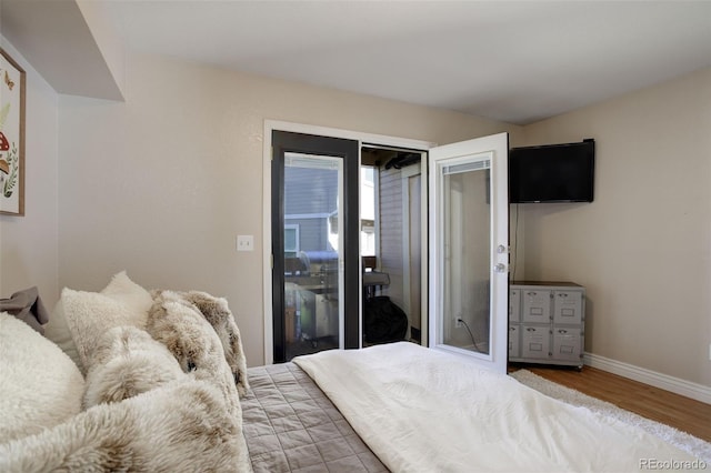 bedroom featuring baseboards and wood finished floors