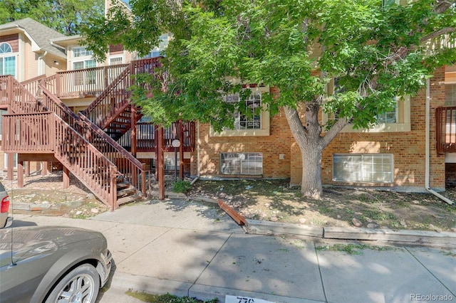 exterior space with brick siding and stairs