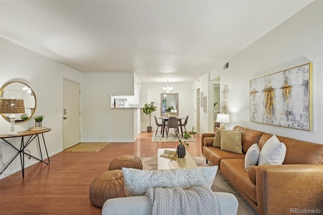 8335 Fairmount Dr Unit 5-106, Denver, CO 80247 - living area with a chandelier, wood finished floors, and baseboards